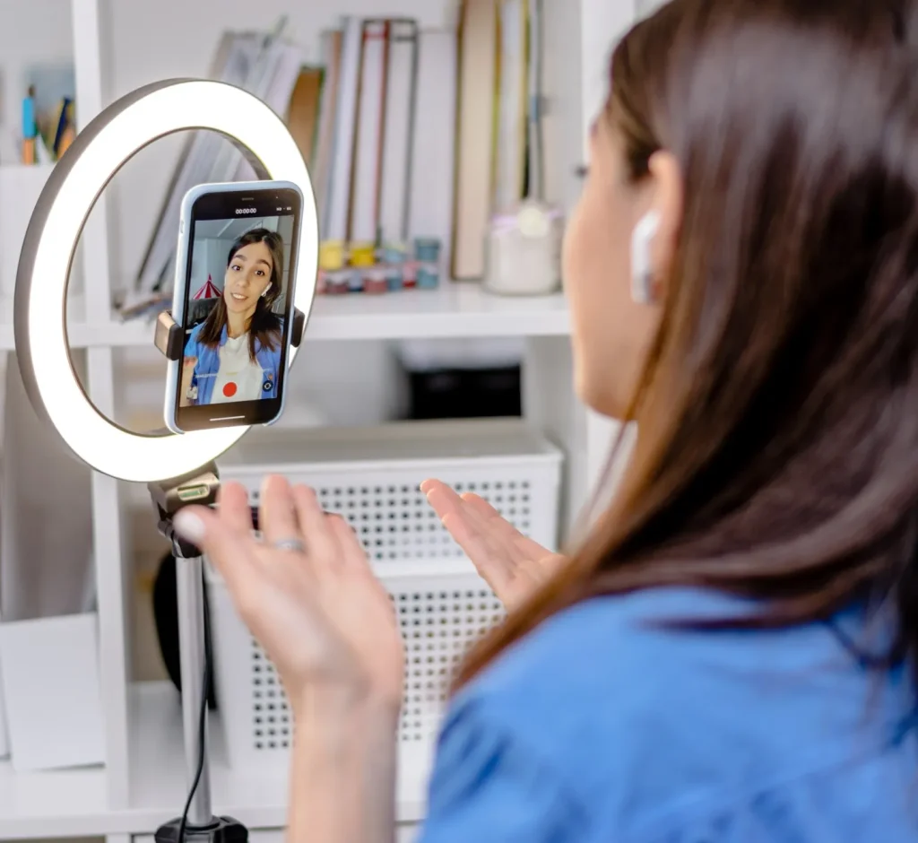 girl blogger influencer talking smartphone live recording video blog on social network at home 1 1